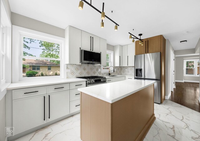 3800 W 82nd St, Chicago, IL 60652 - kitchen featuring appliances with stainless steel finishes, light marble finish flooring, tasteful backsplash, a kitchen island, and light countertops