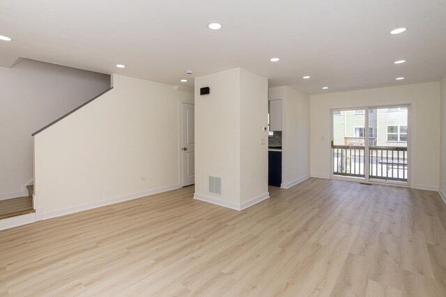 34382 N Aster Ct, Round Lake Beach, IL 60073 - unfurnished living room with light wood finished floors, recessed lighting, and stairway