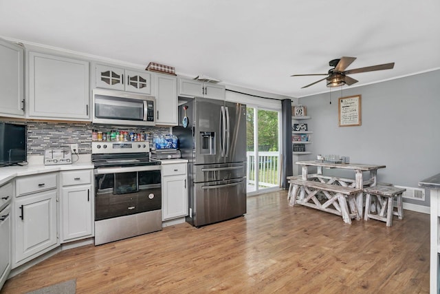 31330 S Seltzer Rd, Wilmington, IL 60481 - kitchen with stainless steel appliances, light countertops, a ceiling fan, tasteful backsplash, and light wood-style floors