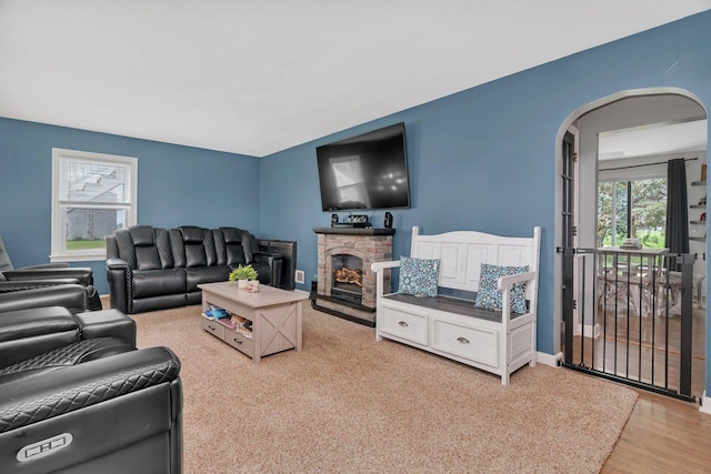 31330 S Seltzer Rd, Wilmington, IL 60481 - living area with arched walkways, a fireplace, and light wood-type flooring