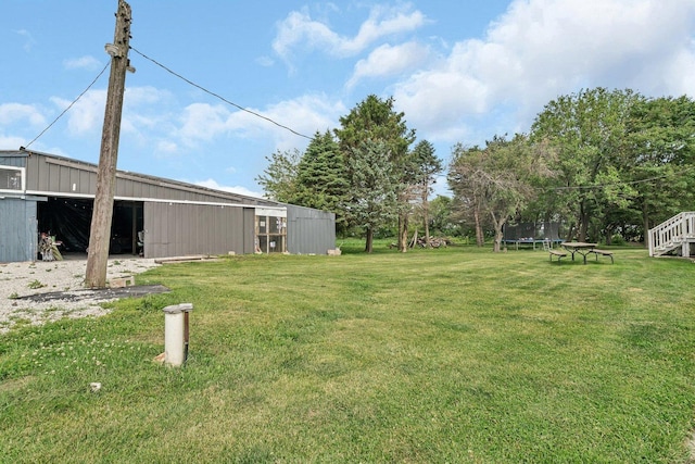 31330 S Seltzer Rd, Wilmington, IL 60481 - view of green lawn featuring a trampoline, a pole building, and an outbuilding