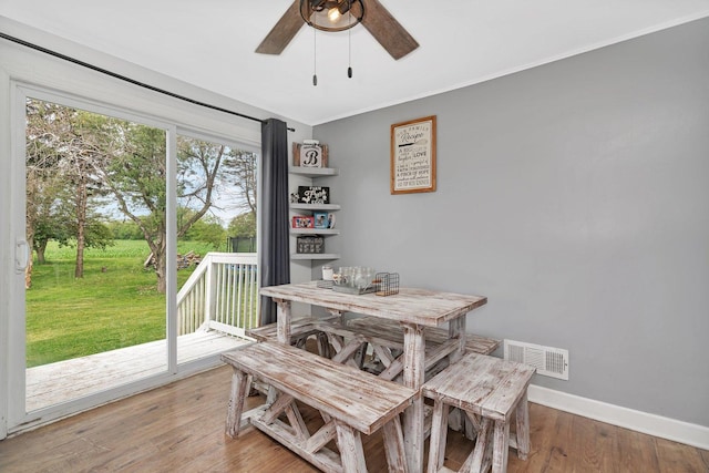 31330 S Seltzer Rd, Wilmington, IL 60481 - dining room featuring a ceiling fan, wood finished floors, and crown molding