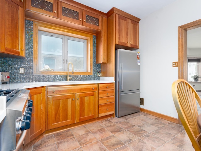 2435 Davisson St, River Grove, IL 60171 - kitchen featuring freestanding refrigerator, stove, decorative backsplash, and light countertops
