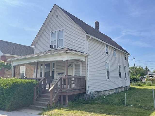 18 E 24th St, Chicago Heights, IL 60411 - view of front facade with a chimney, a porch, and a front yard