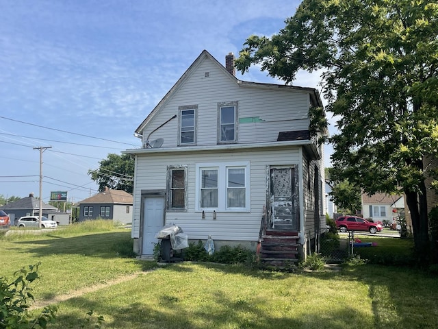 18 E 24th St, Chicago Heights, IL 60411 - rear view of house with a lawn and a chimney
