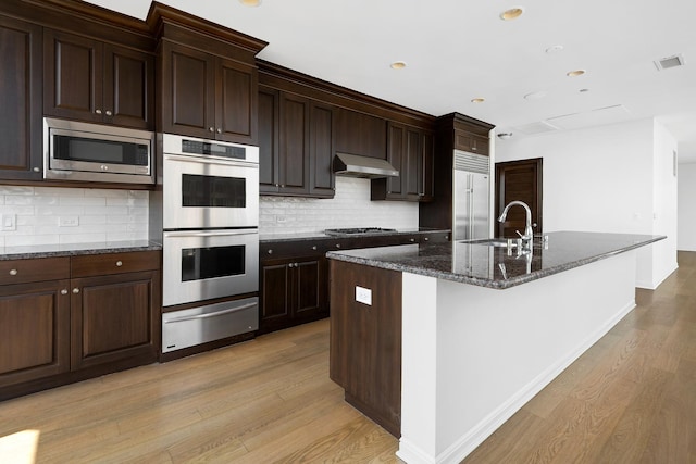 21 E Huron St Unit 4701, Chicago, IL 60611 - kitchen featuring a warming drawer, built in appliances, light wood-style floors, under cabinet range hood, and recessed lighting