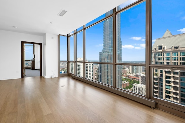 21 E Huron St Unit 4701, Chicago, IL 60611 - unfurnished room with wood finished floors, a wall of windows, and a view of city