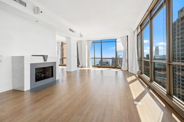 21 E Huron St Unit 4701, Chicago, IL 60611 - unfurnished living room with wood finished floors, a fireplace with flush hearth, and floor to ceiling windows