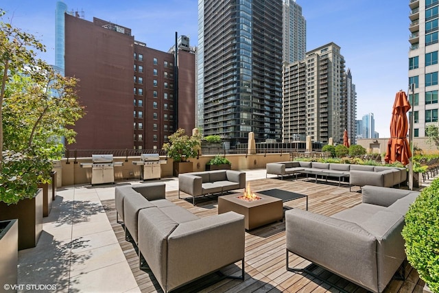 21 E Huron St Unit 4701, Chicago, IL 60611 - view of patio featuring an outdoor living space with a fire pit, a city view, and area for grilling