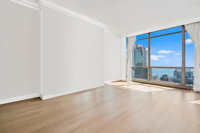 21 E Huron St Unit 4701, Chicago, IL 60611 - empty room featuring wood finished floors, a wall of windows, and crown molding