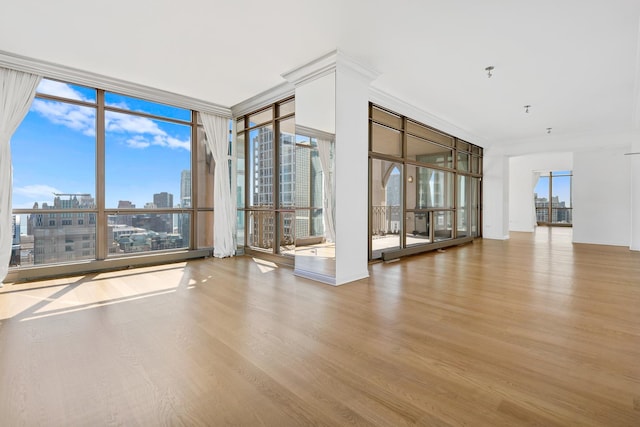 21 E Huron St Unit 4701, Chicago, IL 60611 - empty room featuring expansive windows, wood finished floors, and a city view