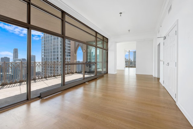 21 E Huron St Unit 4701, Chicago, IL 60611 - empty room with wood finished floors, ornamental molding, and a skyline view