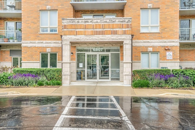 6807 N Milwaukee Ave Unit 411, Niles, IL 60714 - property entrance featuring brick siding and uncovered parking