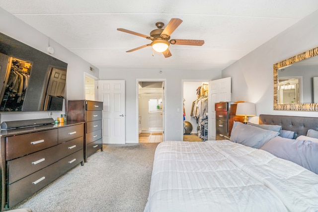 6807 N Milwaukee Ave Unit 411, Niles, IL 60714 - bedroom featuring a spacious closet, a closet, light colored carpet, ensuite bathroom, and ceiling fan
