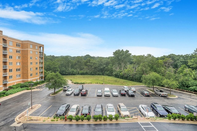 6807 N Milwaukee Ave Unit 411, Niles, IL 60714 - view of building exterior featuring uncovered parking and a forest view
