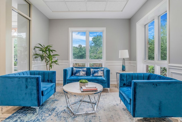 6807 N Milwaukee Ave Unit 411, Niles, IL 60714 - living area with healthy amount of natural light, wainscoting, and a decorative wall