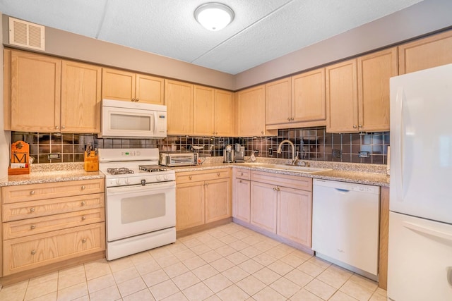 6807 N Milwaukee Ave Unit 411, Niles, IL 60714 - kitchen featuring white appliances, light brown cabinetry, backsplash, light tile patterned floors, and a textured ceiling