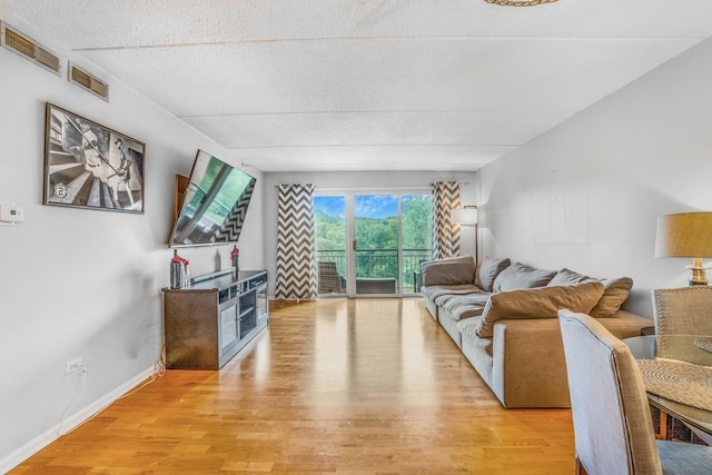 6807 N Milwaukee Ave Unit 411, Niles, IL 60714 - living area featuring light wood finished floors and a textured ceiling