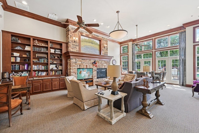 1845 Avon Dr, Hoffman Estates, IL 60192 - living room with light colored carpet, ornamental molding, ceiling fan, a towering ceiling, and a stone fireplace