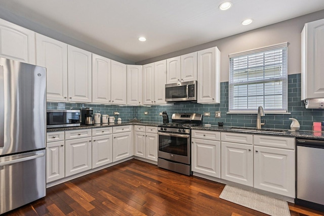 1845 Avon Dr, Hoffman Estates, IL 60192 - kitchen with stainless steel appliances, dark wood-type flooring, white cabinets, decorative backsplash, and recessed lighting