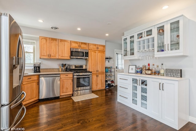 127 Elm St, Glenview, IL 60025 - kitchen with appliances with stainless steel finishes, light countertops, glass insert cabinets, dark wood-style flooring, and recessed lighting