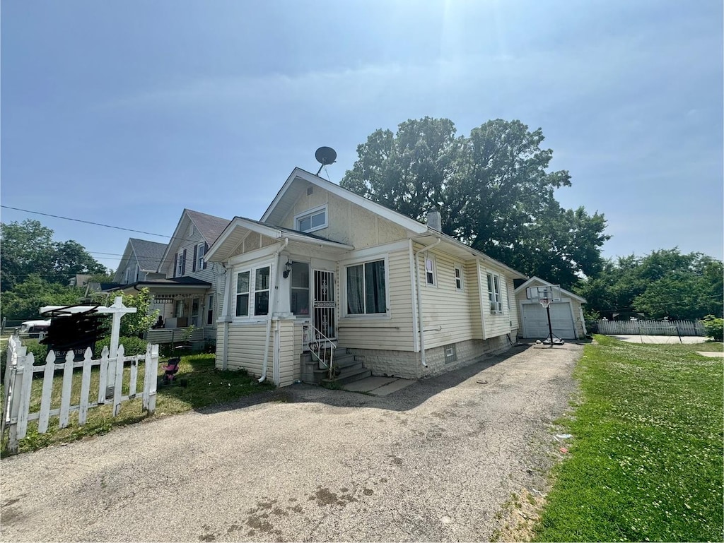 109 Seminary Ave, Aurora, IL 60505 - view of front of home featuring a garage, entry steps, and an outdoor structure