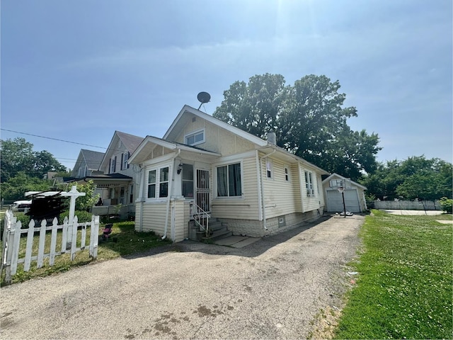 109 Seminary Ave, Aurora, IL 60505 - view of front of home featuring a garage, entry steps, and an outdoor structure