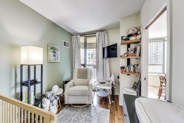 400 N La Salle Dr Unit 1607, Chicago, IL 60654 - bedroom featuring multiple windows, wood finished floors, and a textured ceiling