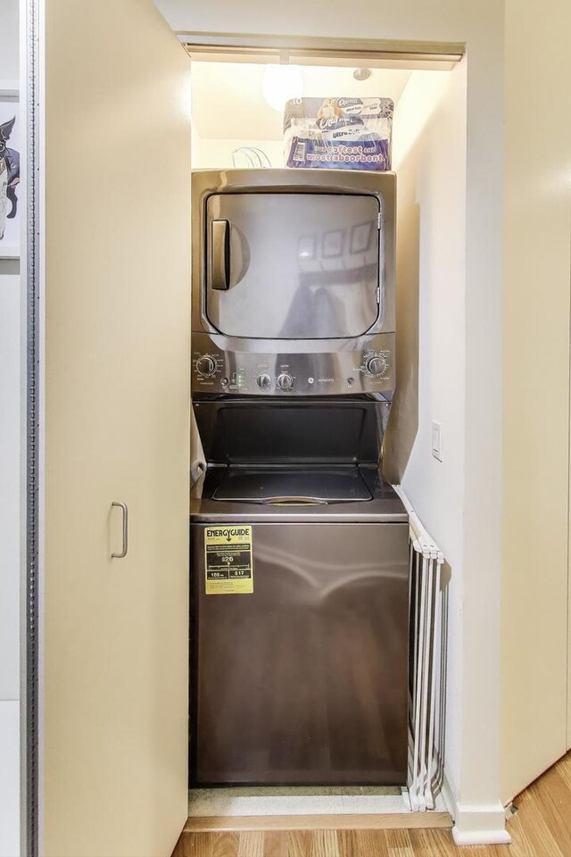 400 N La Salle Dr Unit 1607, Chicago, IL 60654 - laundry area with stacked washer and clothes dryer and wood finished floors