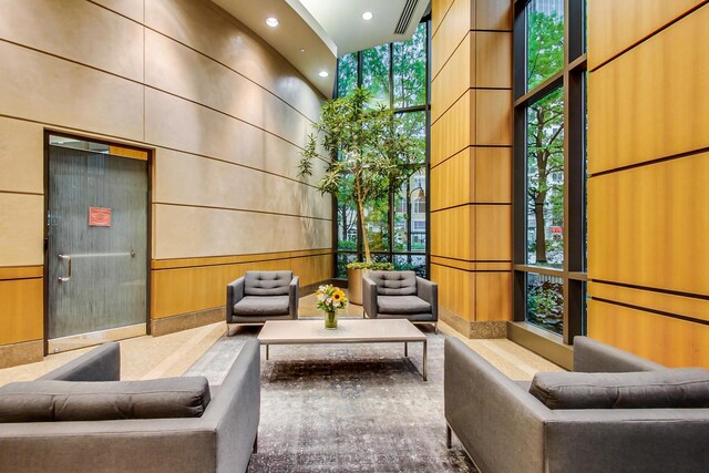 400 N La Salle Dr Unit 1607, Chicago, IL 60654 - lobby featuring a towering ceiling, floor to ceiling windows, recessed lighting, and wooden walls