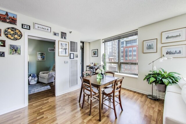 400 N La Salle Dr Unit 1607, Chicago, IL 60654 - dining area featuring light wood finished floors and a textured ceiling