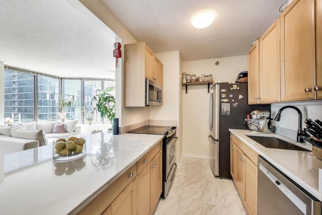 400 N La Salle Dr Unit 1607, Chicago, IL 60654 - kitchen with stainless steel appliances, a textured ceiling, light marble finish floors, light countertops, and light brown cabinetry