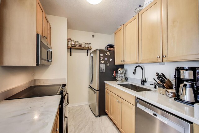 400 N La Salle Dr Unit 1607, Chicago, IL 60654 - kitchen featuring stainless steel appliances, light brown cabinetry, light countertops, light marble finish flooring, and a textured ceiling