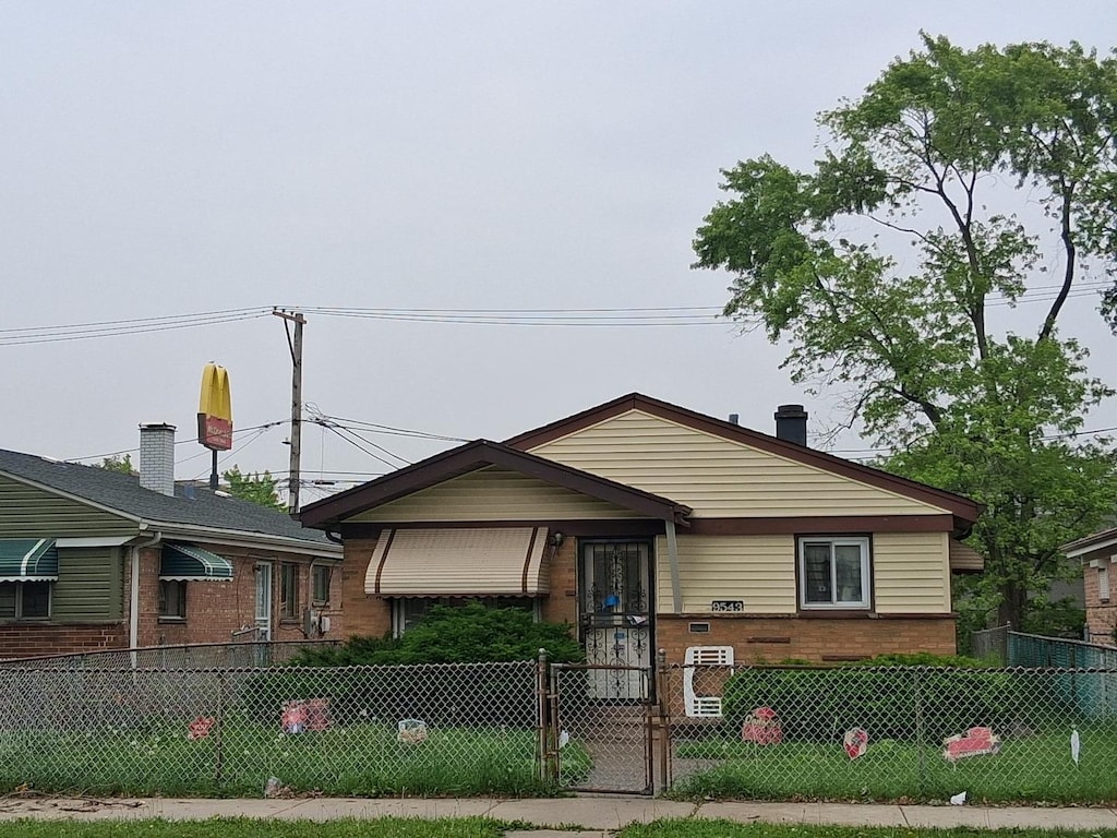 9543 S Green St, Chicago, IL 60643 - tri-level home with a fenced front yard, a gate, and brick siding