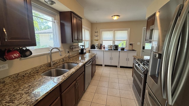 1317 N Mitchell Ave, Arlington Heights, IL 60004 - kitchen featuring appliances with stainless steel finishes, dark brown cabinets, light tile patterned floors, and light stone counters