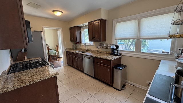1317 N Mitchell Ave, Arlington Heights, IL 60004 - kitchen with stainless steel appliances, dark brown cabinetry, and light tile patterned flooring