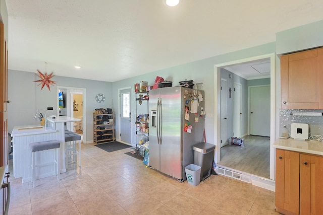 1452 Raymond St, South Elgin, IL 60177 - kitchen featuring stainless steel fridge with ice dispenser, light countertops, tasteful backsplash, recessed lighting, and light tile patterned floors