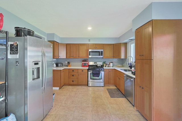 1452 Raymond St, South Elgin, IL 60177 - kitchen with stainless steel appliances, light countertops, light tile patterned flooring, brown cabinets, and decorative backsplash