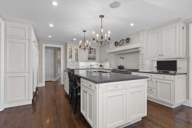 1300 Hackberry Ln, Winnetka, IL 60093 - kitchen featuring dark countertops, a chandelier, tasteful backsplash, white cabinetry, and dark wood-style flooring