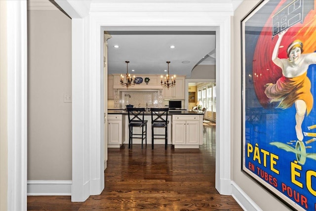 1300 Hackberry Ln, Winnetka, IL 60093 - hallway featuring a chandelier, dark wood finished floors, ornamental molding, and recessed lighting