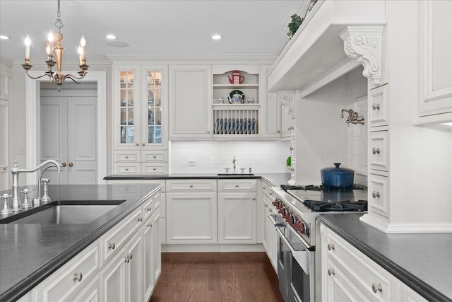 1300 Hackberry Ln, Winnetka, IL 60093 - kitchen featuring high end stove, dark countertops, a chandelier, white cabinets, and decorative light fixtures