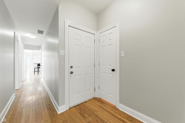 3302 W Crystal St Unit 3, Chicago, IL 60651 - kitchen with appliances with stainless steel finishes, a peninsula, light wood-type flooring, a breakfast bar, and pendant lighting