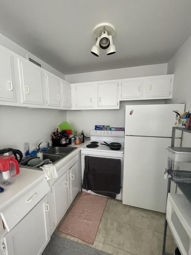 6171 N Sheridan Rd Unit 1910, Chicago, IL 60660 - kitchen featuring white appliances, white cabinetry, light countertops, and light tile patterned floors