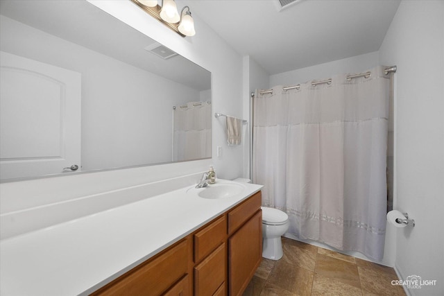 808 Karen Dr, Hampshire, IL 60140 - bathroom featuring vanity, stone finish floors, and curtained shower