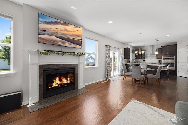 808 Karen Dr, Hampshire, IL 60140 - living room with a fireplace with flush hearth, recessed lighting, dark wood finished floors, and a chandelier