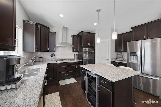 808 Karen Dr, Hampshire, IL 60140 - kitchen featuring appliances with stainless steel finishes, wall chimney range hood, beverage cooler, a kitchen island, and dark wood finished floors