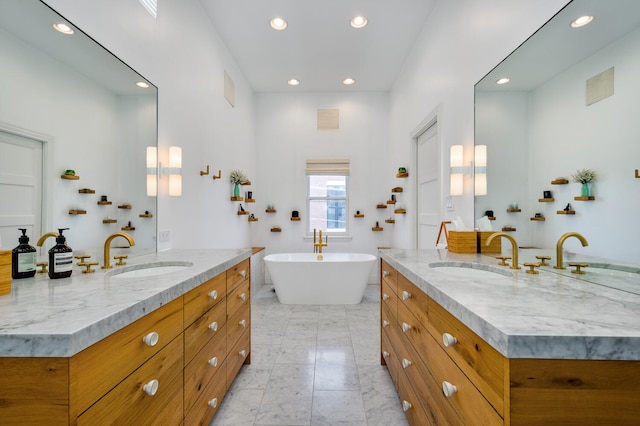 824 W Armitage Ave Unit 2Cd, Chicago, IL 60614 - bathroom with two vanities, recessed lighting, marble finish floors, and a freestanding bath
