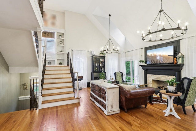 51 Mitchell Cir, Wheaton, IL 60189 - living area featuring a chandelier, stairs, high vaulted ceiling, wood finished floors, and a fireplace