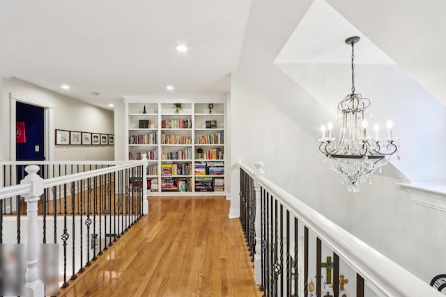51 Mitchell Cir, Wheaton, IL 60189 - hallway featuring an upstairs landing, a chandelier, wood finished floors, built in shelves, and recessed lighting