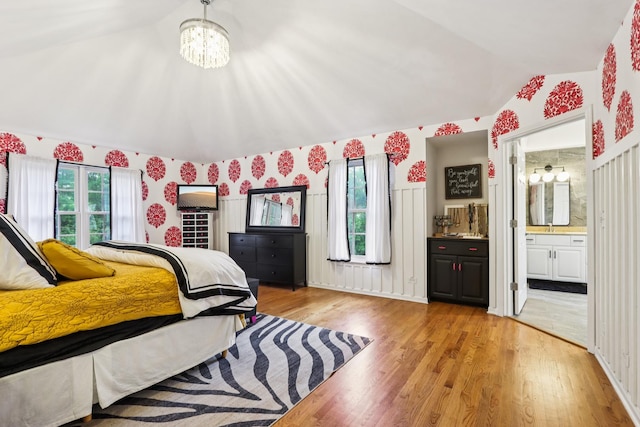 51 Mitchell Cir, Wheaton, IL 60189 - bedroom with lofted ceiling, light wood-style flooring, a chandelier, wallpapered walls, and ensuite bathroom